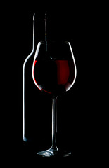 silhouette a glass and bottle on a black isolated background