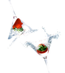 splashing strawberry into a cocktail glass.
