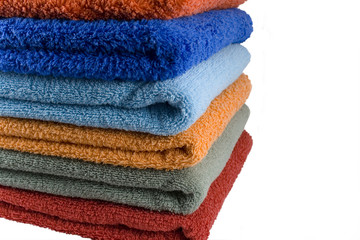 Stack of coloured towels isolataed over white