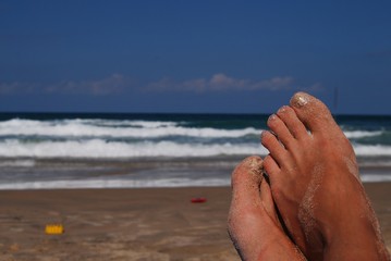 female feet on back-ground sea in sand.