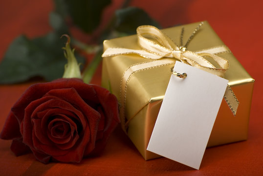 golden present with red rose close up shoot