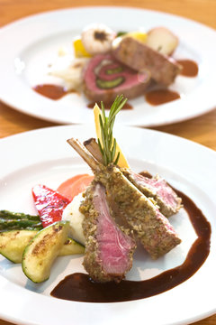 Crusted Lamb Chops Served With Zucchini And Peppers