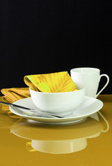 A modern table setting with white dishes 