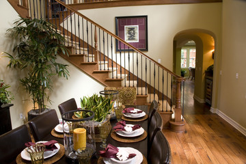 Modern dining table and hallway with hardwood flooring.