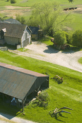 Farm buildings and farmhouse in countryside.