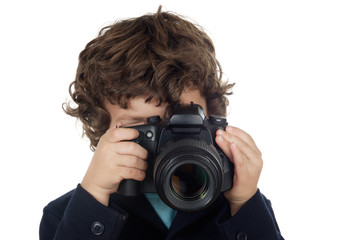 Young boy taking photo with camera over white background