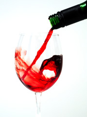 Red wine pouring into a glass