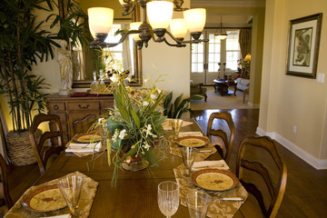 Festive dining table with a chandelier and luxurious decor.