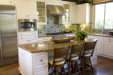 Estate kitchen with an island and modern appliances.