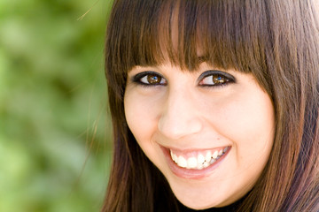 Fototapeta premium Happy girl portrait against green background