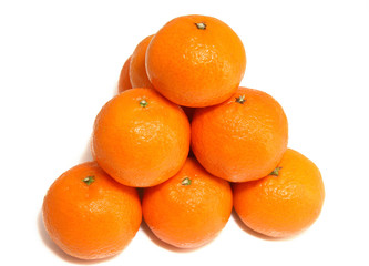 Pyramid from tasty ripe tangerines on a white background.