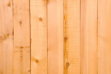 Background image of fresh wood plank fencing.