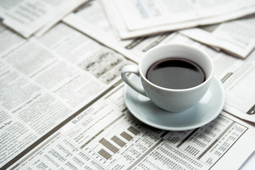 Coffee over newspaper, business
