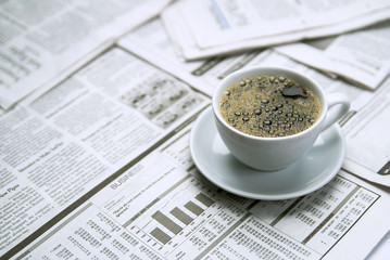Coffee over newspaper, business