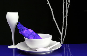 Comptemporary dishes set for dinner in blue and purple