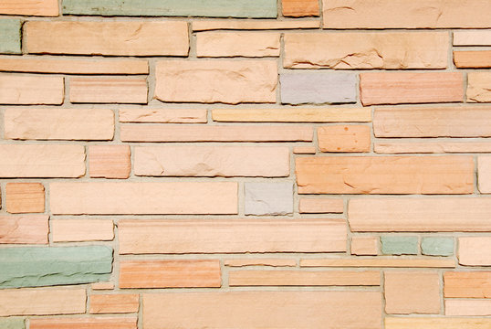 Background image of multi-colored sandstone wall.