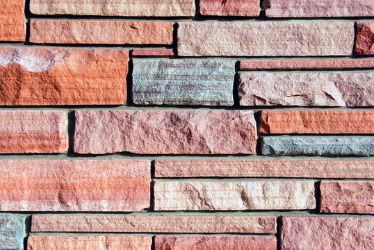Background image of multi-colored sandstone wall.