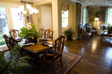 Modern dining table and hallway with hardwood flooring.