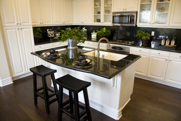 Luxury home kitchen with a granite top island.  - obrazy, fototapety, plakaty
