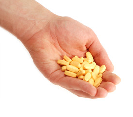 Fototapeta premium Hand full of pills and vitamins