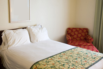 Bed and chair in a business travel hotel room