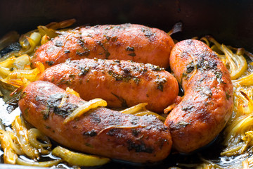 Baked pork sausages with onion and spices.