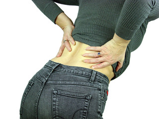 Female with a backache puts her hands on her back