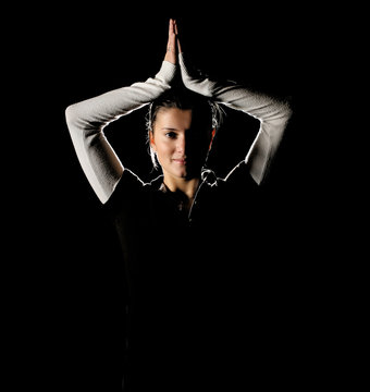 Young Woman Portrait Over Black Backround In Yoga Style