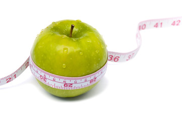 Green apple with measuring tape. Weight loss concept.
