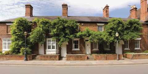 A row of cottage decorated with flowers 