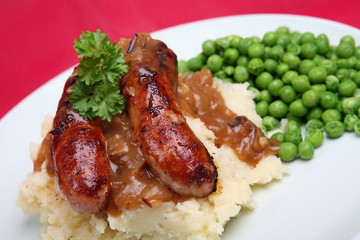 Sausages and mashed potato with onion gravy and peas