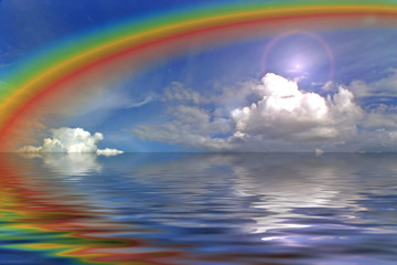 clouds sky and rainbow in the ocean wih flare