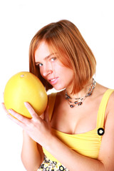 Girl holds in really big citrus fruit - pamelo