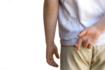 little girl crossing fingers behind her backed. Concept of lie