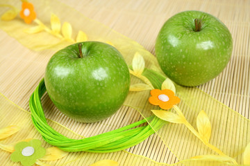 Beautiful natural green apples and decorated bamboo mat