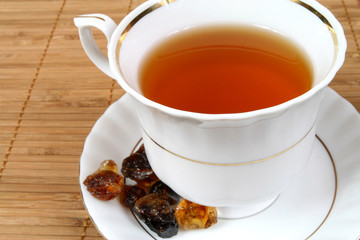 Tea cup and brown sugar. Hot drink.