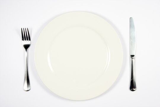 A place setting for dinner against white background