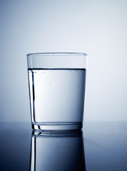 Glass of fresh water, coloured with blue