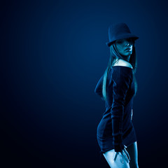 Sexy woman with shot in studio tinted blue