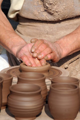 Hands of a man making cups