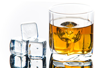 Whiskey in glass with ice cubes