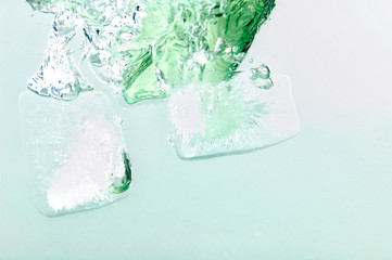 Ice cube fall in an refreshing drink .