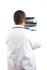 Doctor in lab coat, examining x-ray against white background