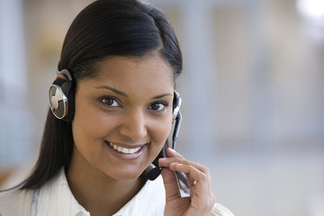 Smiling call center woman holding her mic