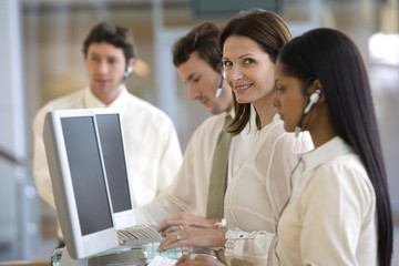 Mature call center woman with colleagues