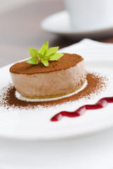 Mocca cheese cake with jam on coffee table