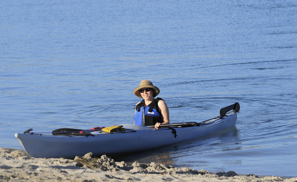 An attractive young woman after a kayak ride