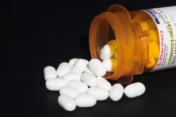 Prescription pills in a plastic medicine bottle.