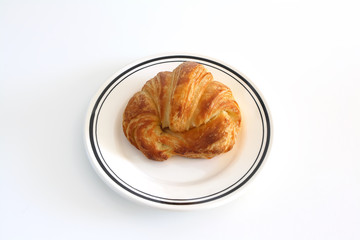 Croisant on white plate on white background