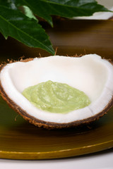 Avocado coconut scrub in coconut shell